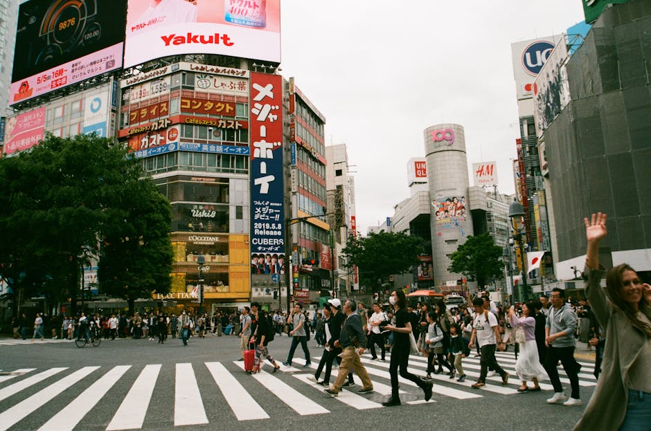 French traveler using smartphone at Tokyo Shibuya Crossing