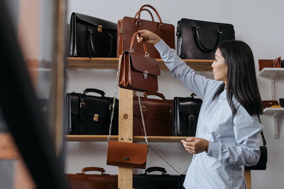 French woman selecting leather handbag Saint Germain boutique