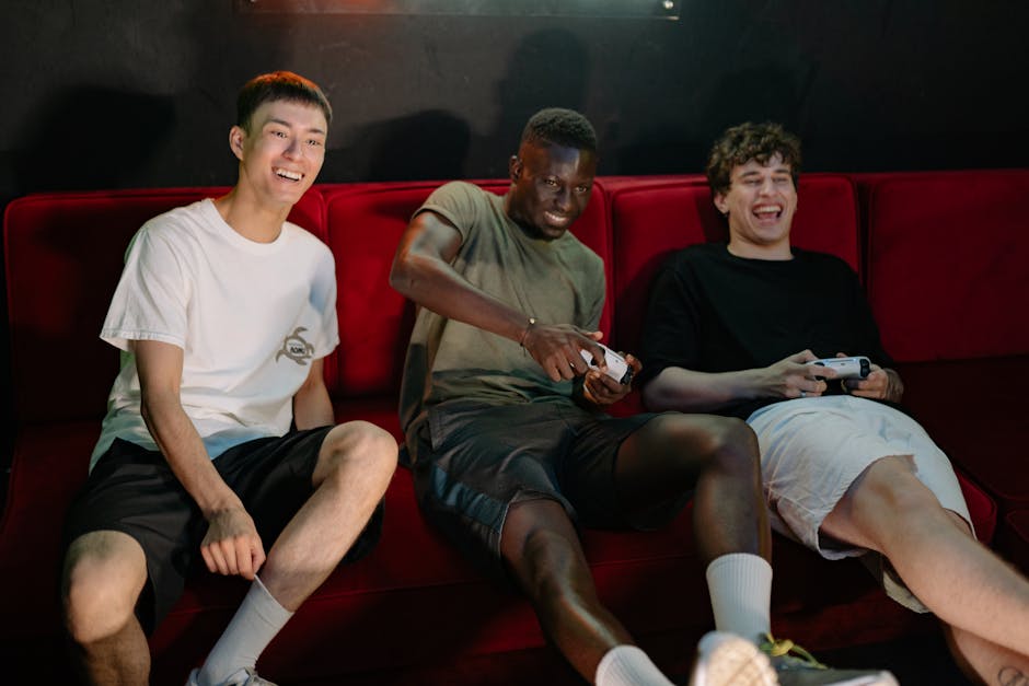 group playing video games on couch laughing