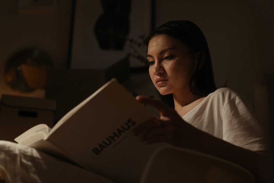 woman reading book cozy Paris apartment evening